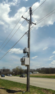 wood utility pole with mounted equipment